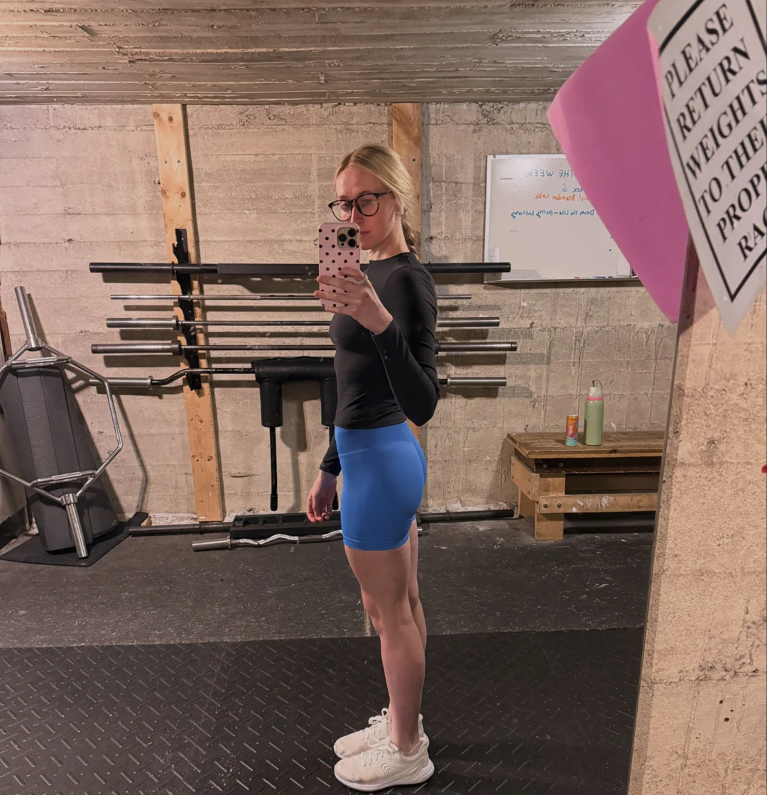 Libby in a gym wearing blue shorts and a dark long-sleeved top